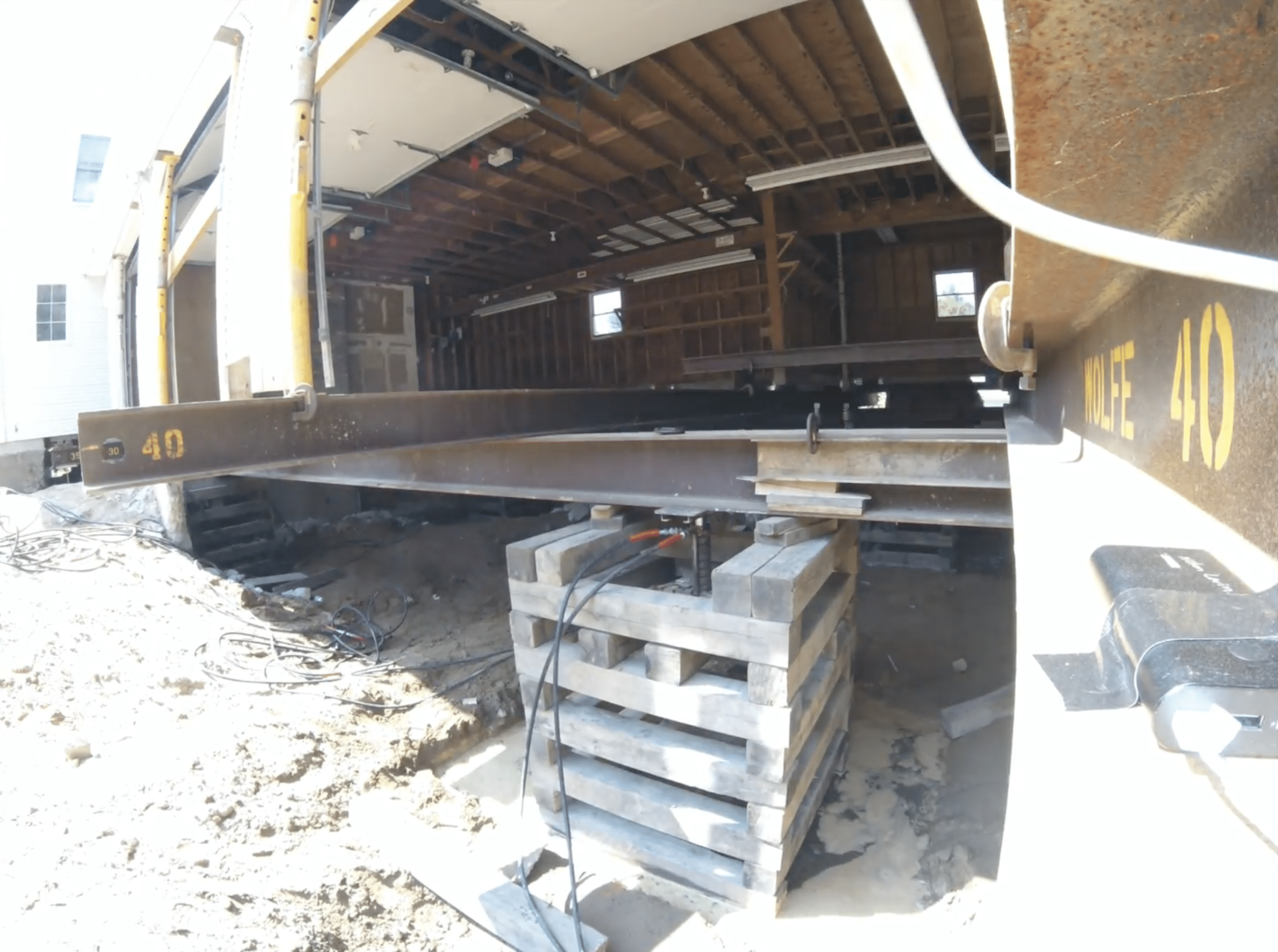 a close up of a house that has been lifted. foundation replacement monson, ma