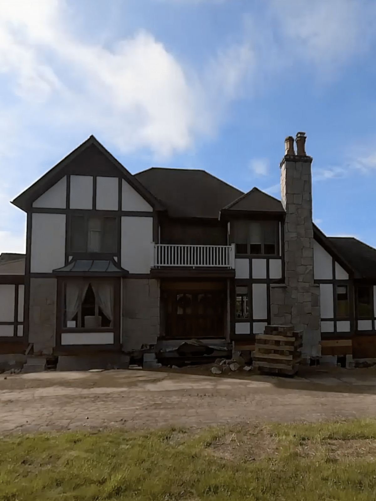 lifted house during foundation replacement. blue sky in the background. ellington, ct